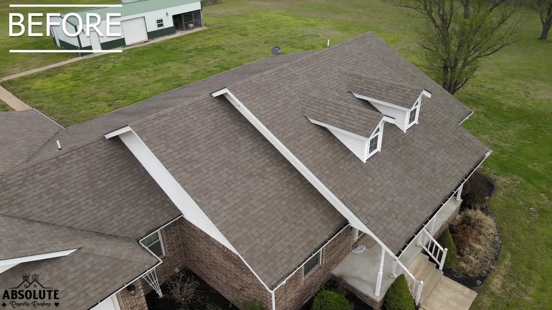 An aerial view of a brick house with a worn brown asphalt shingle roof, labeled 'BEFORE' in the corner.